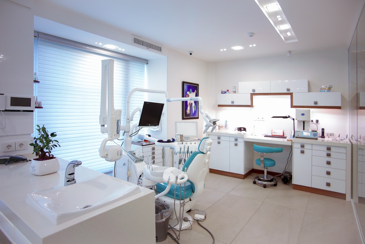 A patient smiling at the dentist while seated in the dental chair